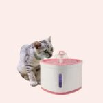 Fontaine d'eau automatique rose et blanc, avec une fleur et un chat qui un chat qui boit de l'eau