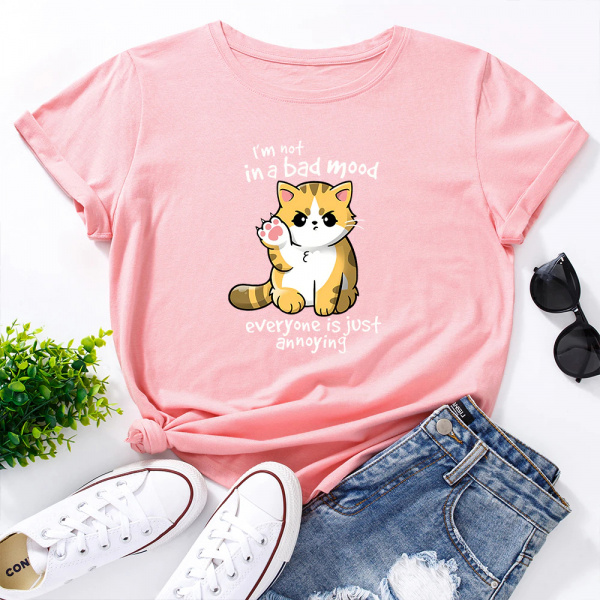 Tee shirt rose avec petit chat roux dessiné, paire de tennis et de jean à cote