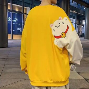 Pull large jaune avec motif de chat blanc dessin animé