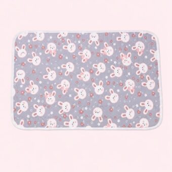 Un tapis rafraichissant chat au motif de lapins mignons gris, plat et rectangulaire, avec de petits lapins roses et blancs dessinés dessus.